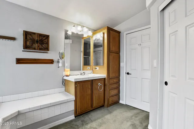 a view of bathroom with a tub sink shower and mirror