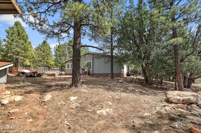 an aerial view of a house with a yard and garden