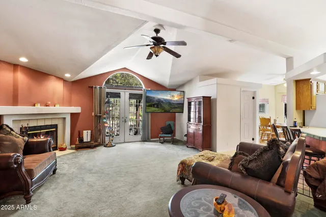 a living room with furniture a fireplace and a chandelier