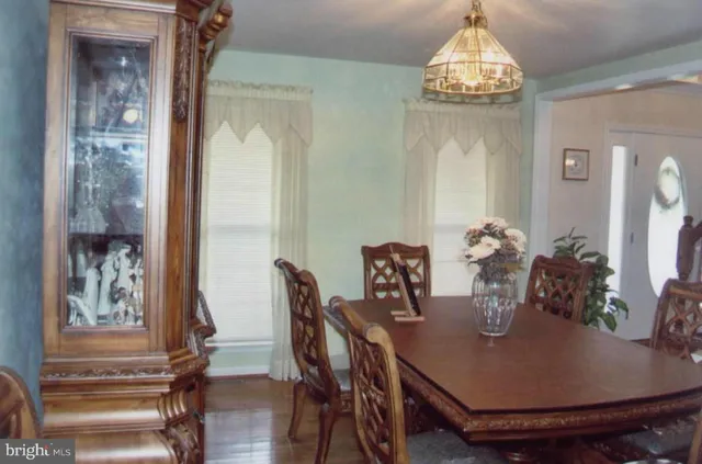 a view of a dining room with furniture wooden floor and chandelier