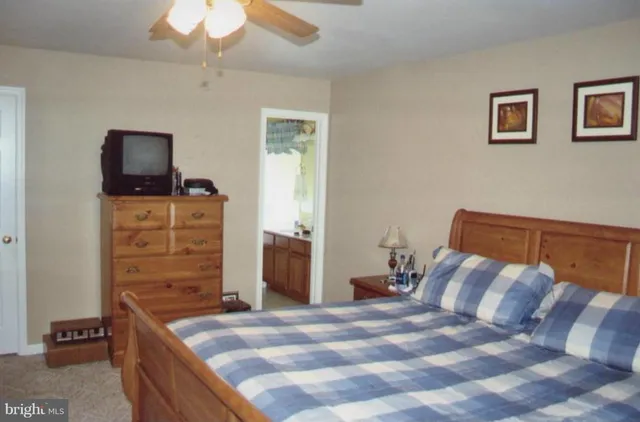 a bedroom with a bed and a television