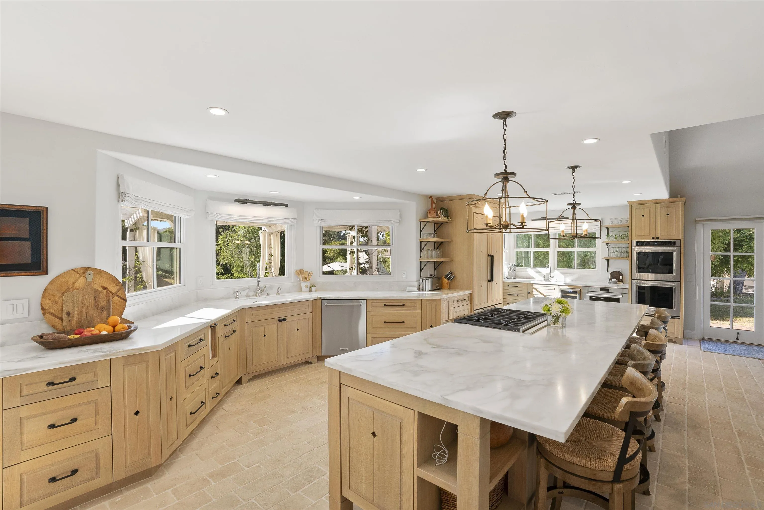 5 Country Glen Road Fallbrook, CA 92028 - Photo 12 of 43 a large kitchen with granite countertop a stove a sink a dining table and chairs