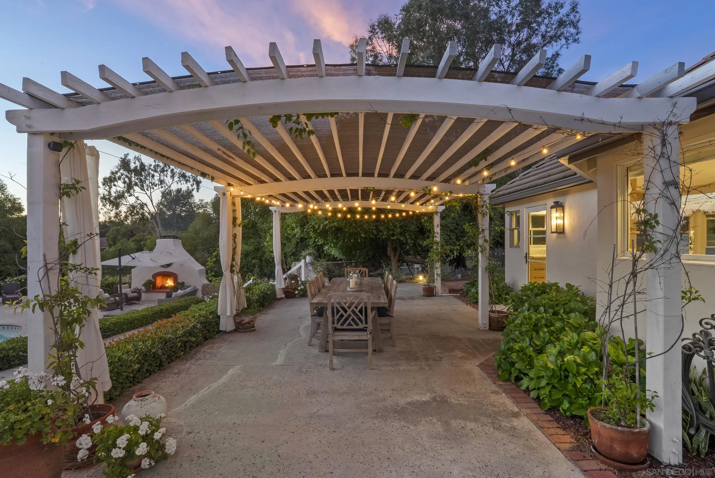5 Country Glen Road Fallbrook, CA 92028 - Photo 18 of 43 a view of a patio with table and chairs potted plants and floor to ceiling window