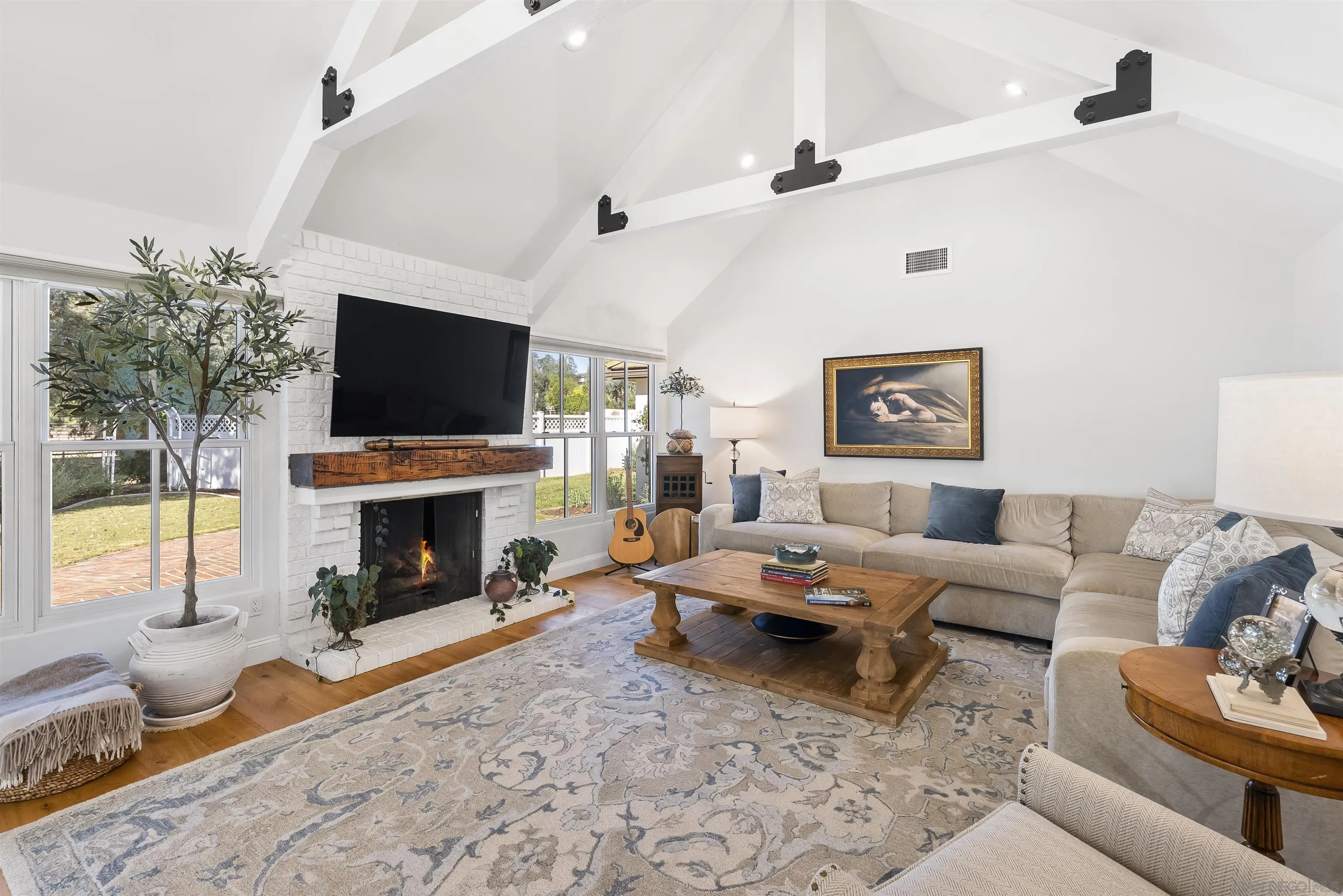 5 Country Glen Road Fallbrook, CA 92028 - Photo 19 of 43 a living room with furniture a fireplace and a flat screen tv