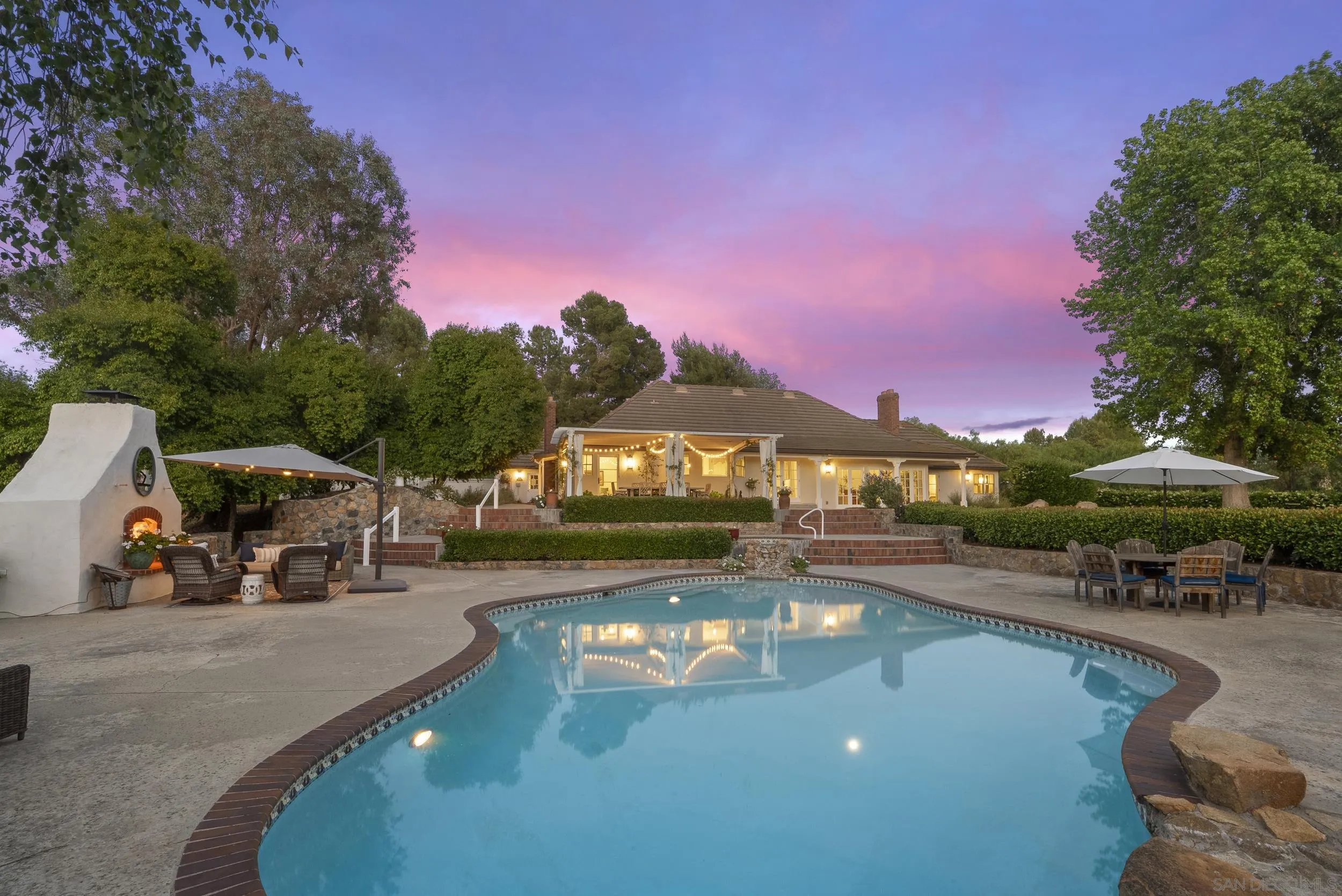 5 Country Glen Road Fallbrook, CA 92028 - Photo 30 of 43 a view of a swimming pool with two chairs in a patio