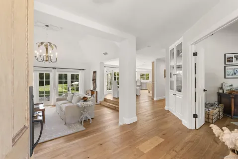a living room with furniture and a chandelier