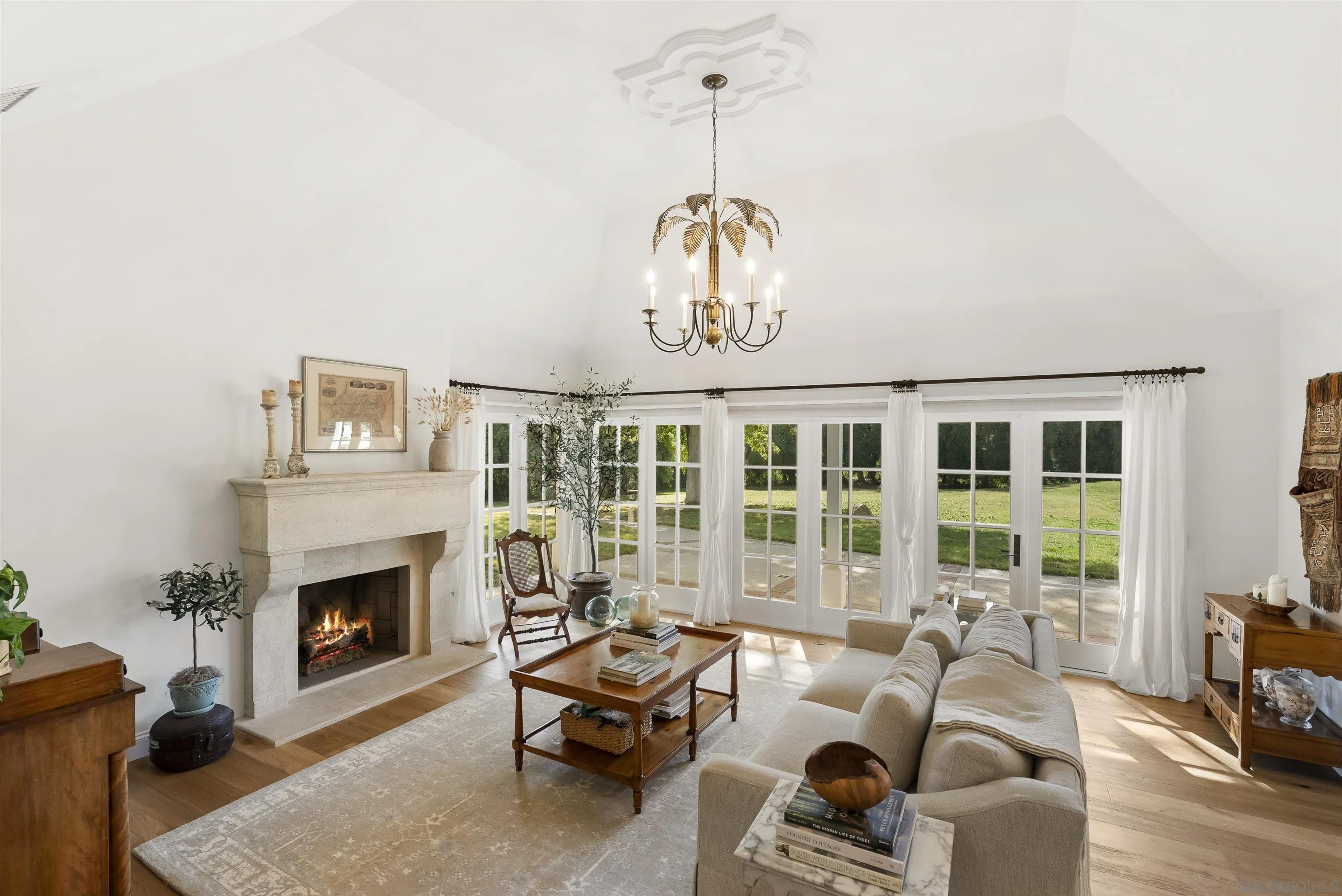 5 Country Glen Road Fallbrook, CA 92028 - Photo 8 of 43 a living room with furniture a fireplace and a chandelier