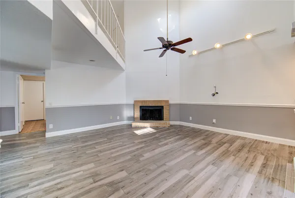 wooden floor in an empty room with a fireplace