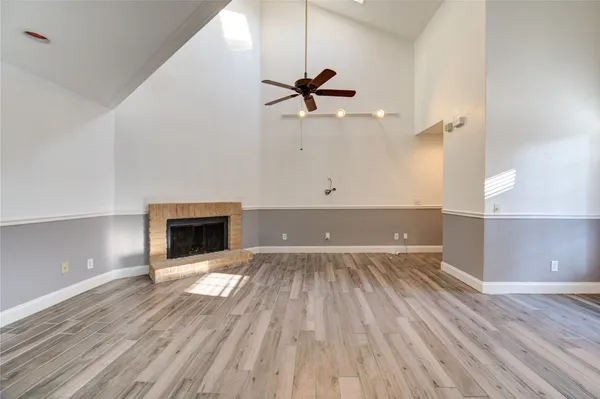 wooden floor in an empty room with a fireplace