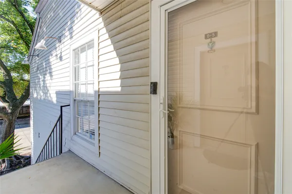 a view of a balcony with wooden floor and fence and a bench