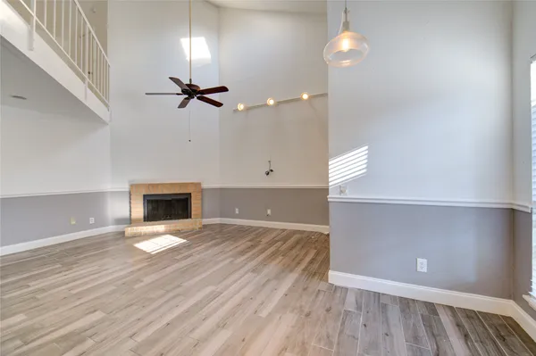 wooden floor in an empty room with a fireplace