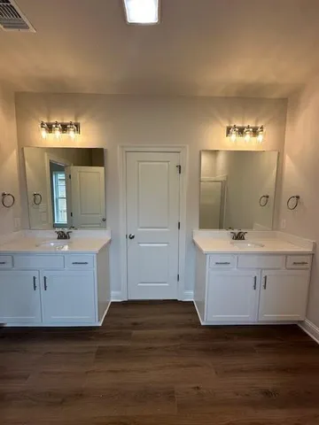a view with a double vanity sink mirror and window