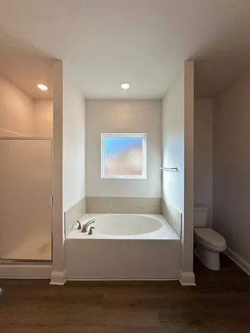 a bathroom with a bathtub and toilet