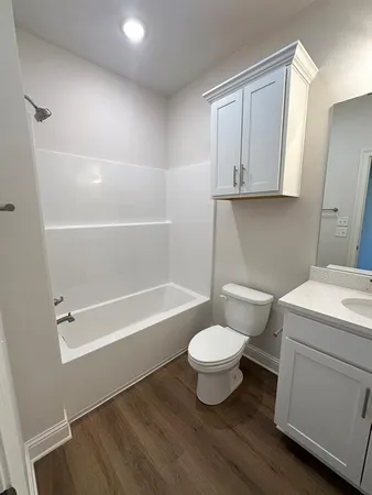 a bathroom with a toilet a sink and bathtub