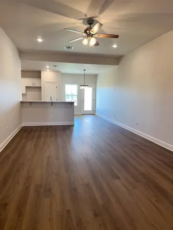 a large kitchen with stainless steel appliances a large oven a stove and a wooden floors