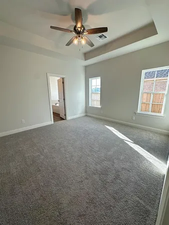 a view of a livingroom with a ceiling fan and window