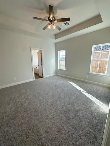 a view of a livingroom with a ceiling fan and window
