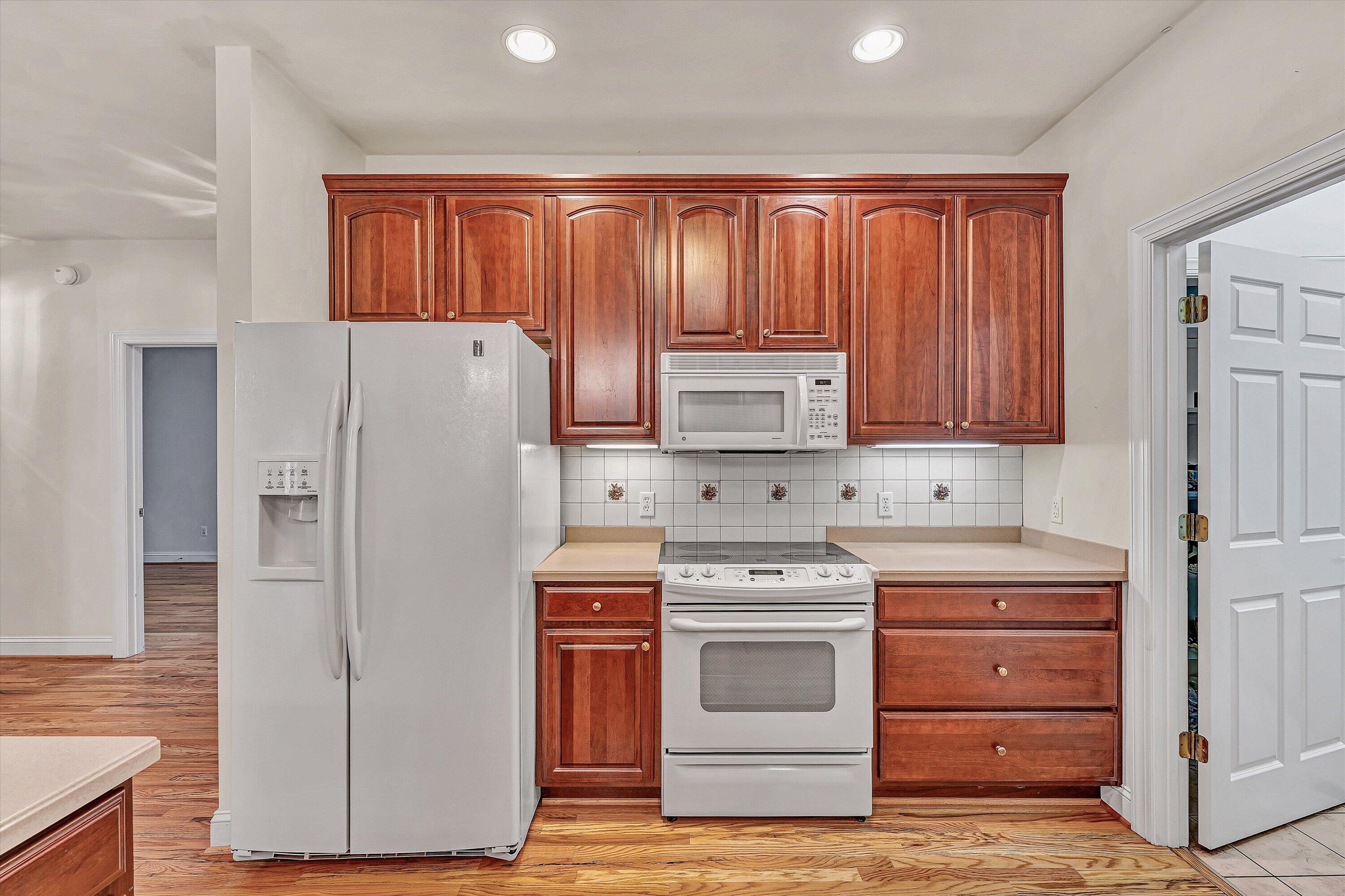 131 Stoney Mill Road Rocky Mount, VA 24151 - Photo 12 of 37 a kitchen with white cabinets and white appliances