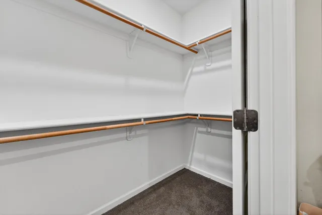 a kitchen with stainless steel appliances granite countertop a stove top oven a sink dishwasher and a refrigerator with wooden floor