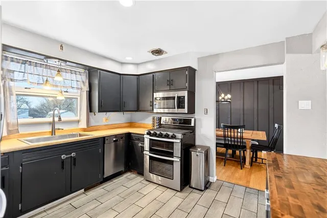 a kitchen with stainless steel appliances granite countertop a stove and a sink