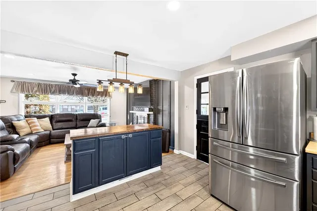 a kitchen with stainless steel appliances granite countertop a refrigerator and a sink