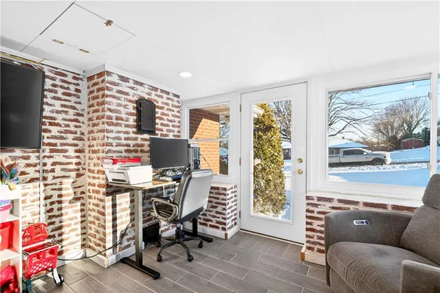 a work room with furniture and a flat screen tv