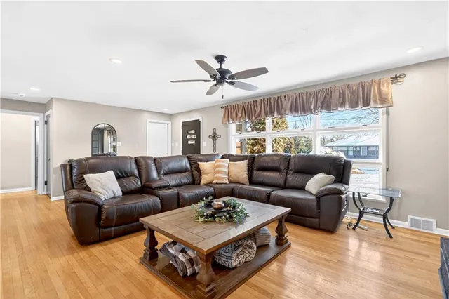 a living room with furniture a rug and a chandelier