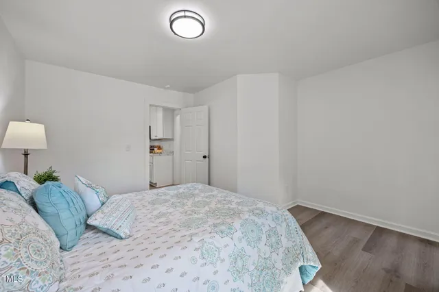 a bedroom with a bed and a lamp