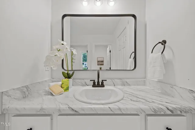 a bathroom with a sink and a mirror