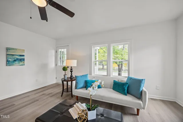 a living room with furniture and wooden floor