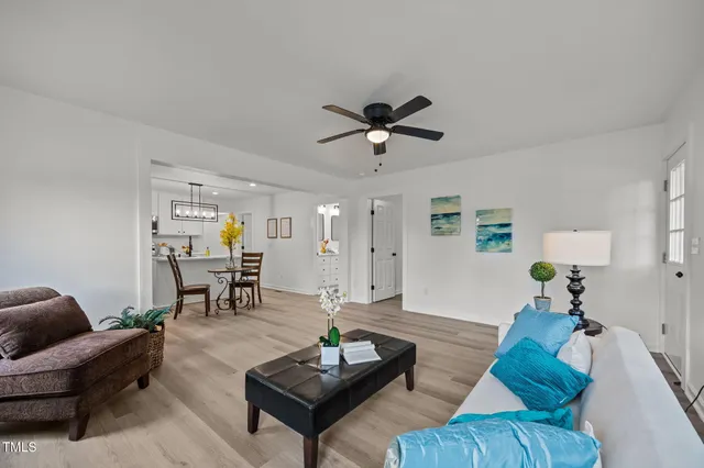 a living room with furniture and wooden floor