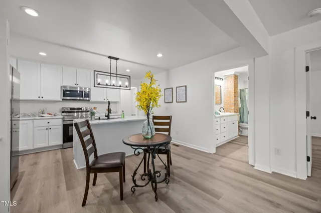 a view of kitchen with furniture and wooden floor