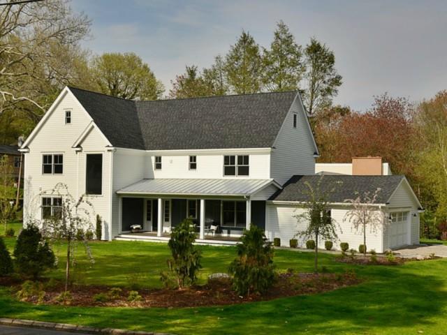 a front view of house with yard and green space