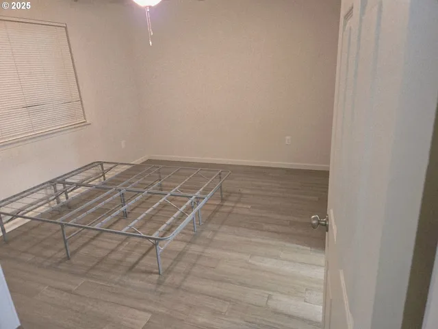 a view of a livingroom with an empty space and wooden floor