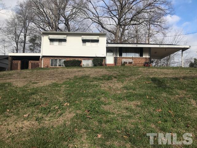 2501 Rock Quarry Road Raleigh, NC 27610 - Photo 1 of 2 a front view of a house with a yard and garage