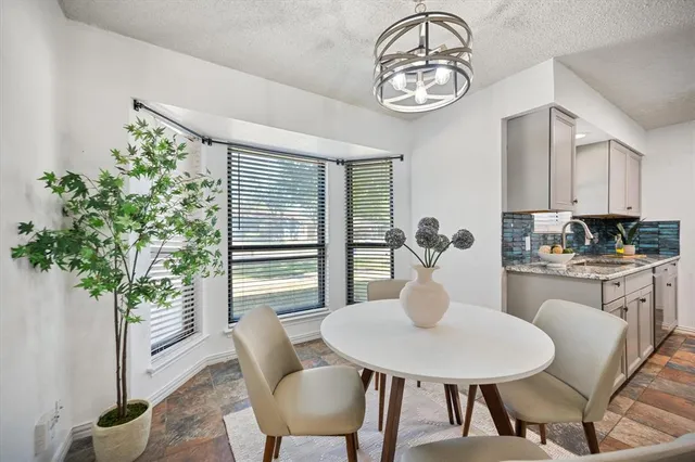 a dining room with furniture a potted plant and a chandelier