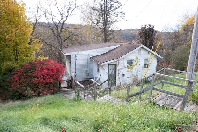 a view of house with backyard and garden