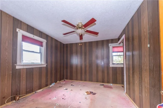 a view of a livingroom with a ceiling fan and window