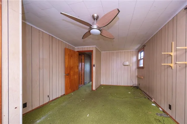 a view of a livingroom with a ceiling fan and entryway