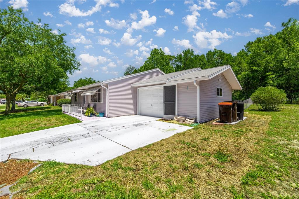 9021 Southwest 108th Place Ocala, FL 34481 - Photo 6 of 30 a front view of a house with a garden and yard