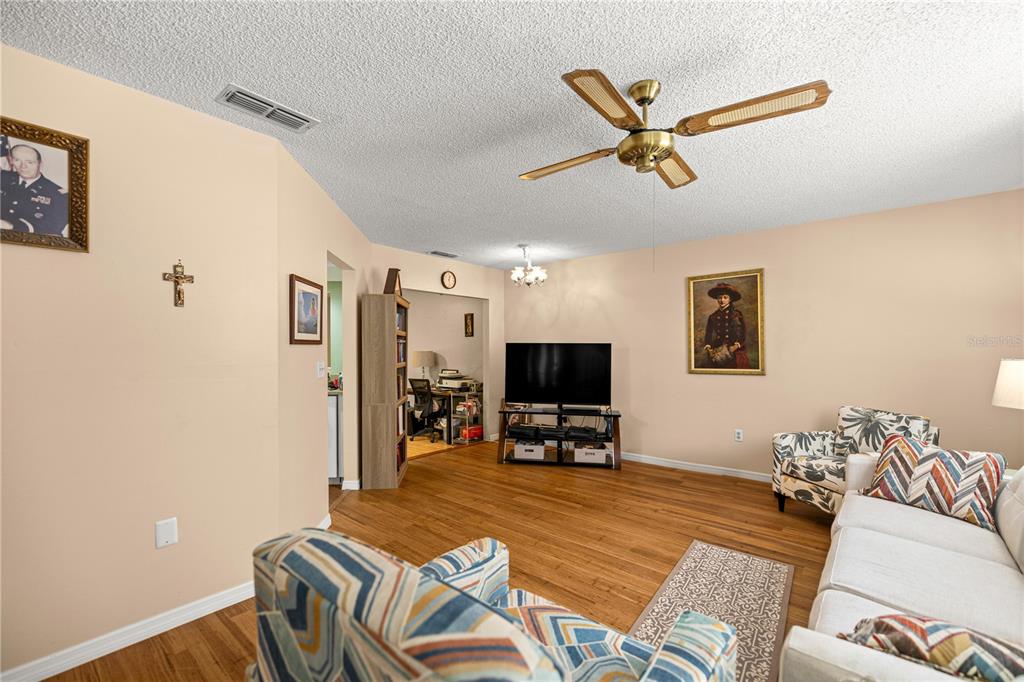 9021 Southwest 108th Place Ocala, FL 34481 - Photo 8 of 30 a living room with furniture and a flat screen tv