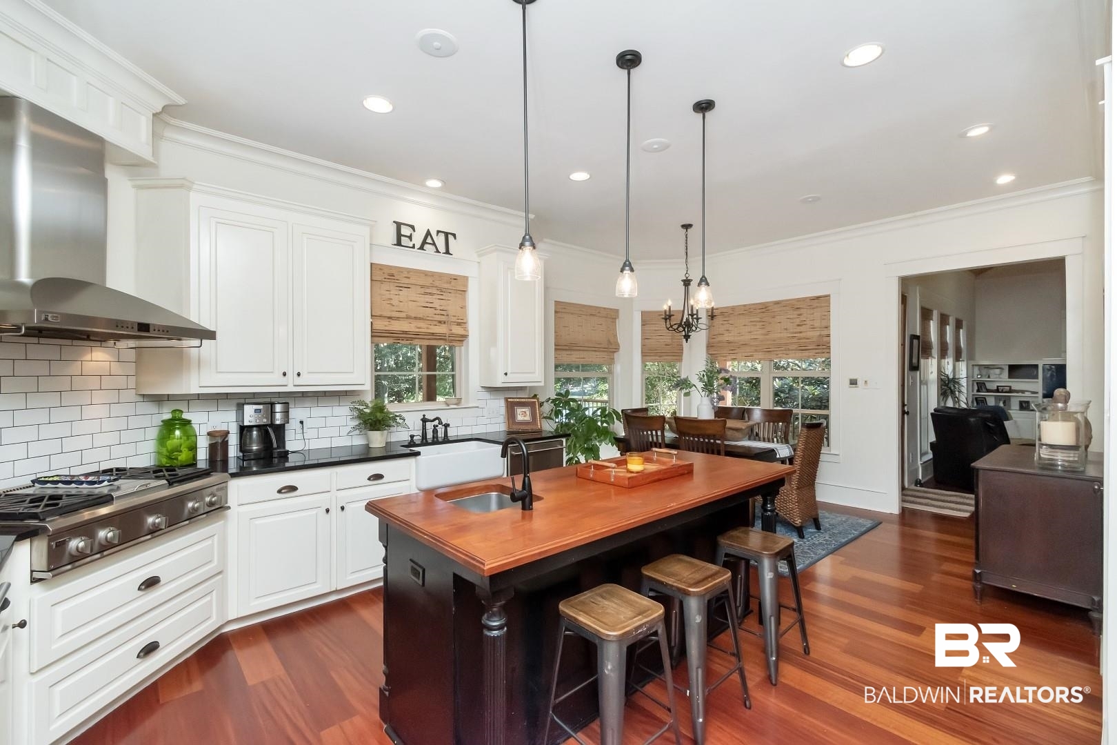 8868 Dawes Lake Road South Mobile, AL 36619 - Photo 13 of 35 Kitchen with dark hardwood / wood-style floors, wall chimney exhaust hood, plenty of natural light, and a kitchen island