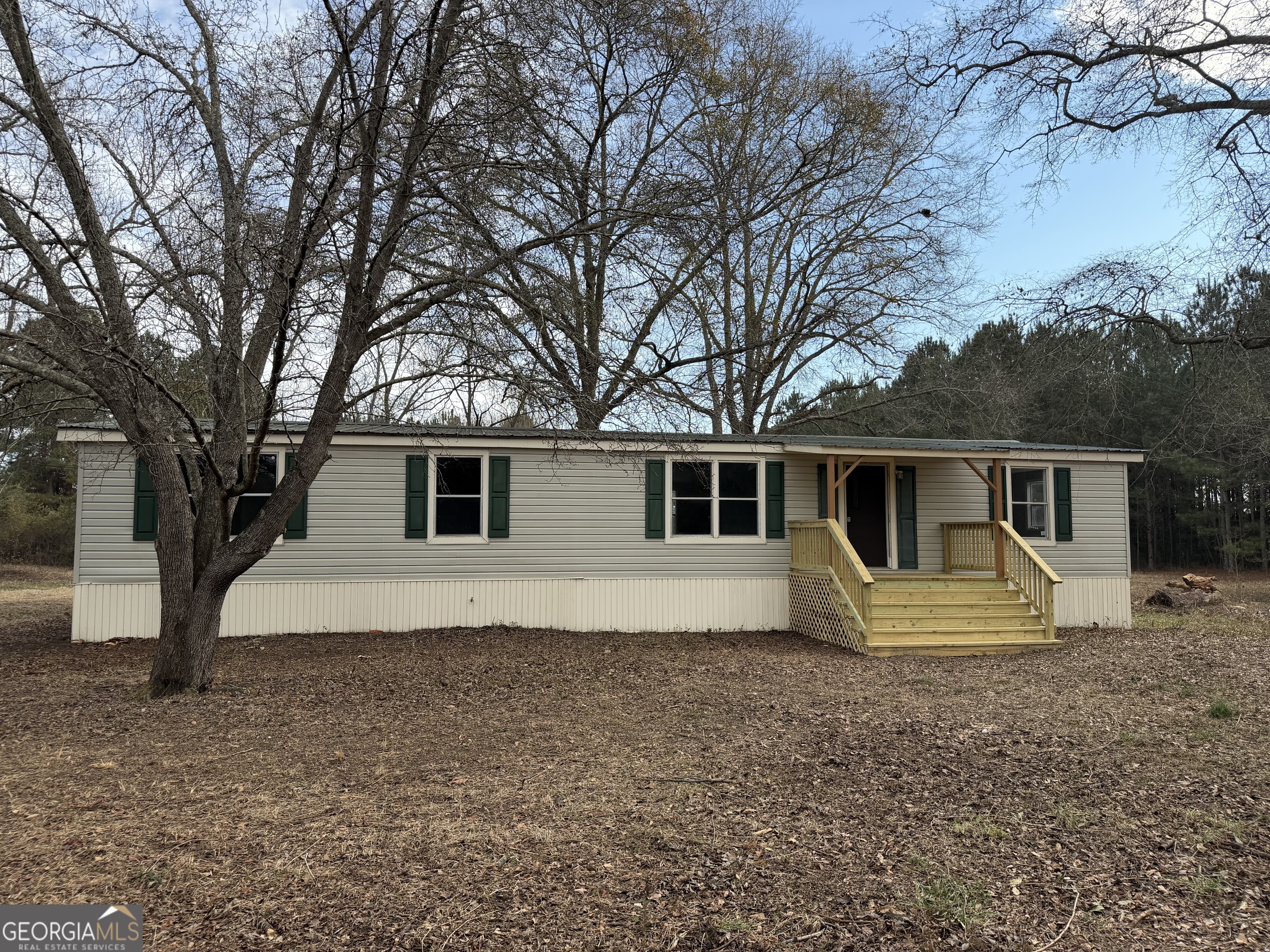 a house that has a tree in front of it