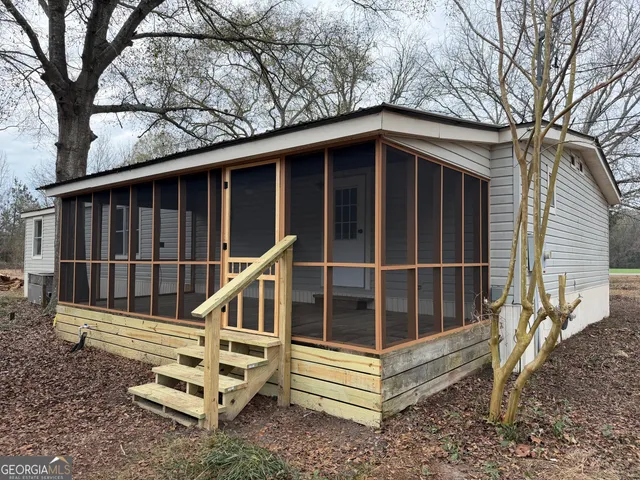 a view of deck with a large window and wooden fence