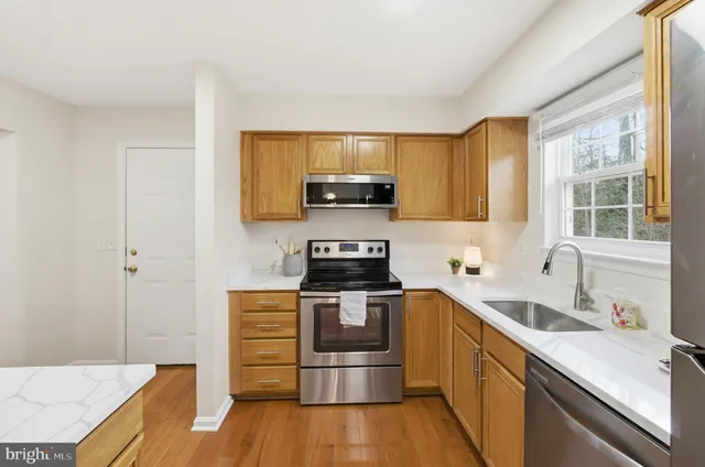 a kitchen with stainless steel appliances a refrigerator and a sink