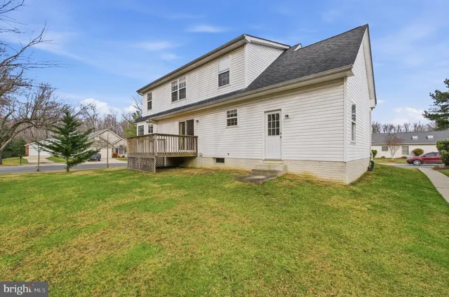 a view of a swimming pool with lawn chairs under an umbrella