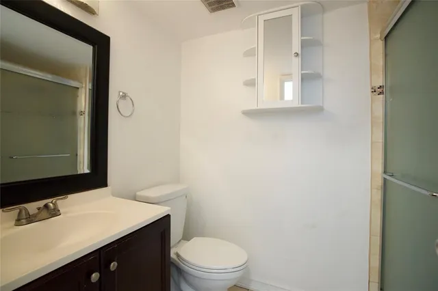 a bathroom with a sink a toilet and mirror