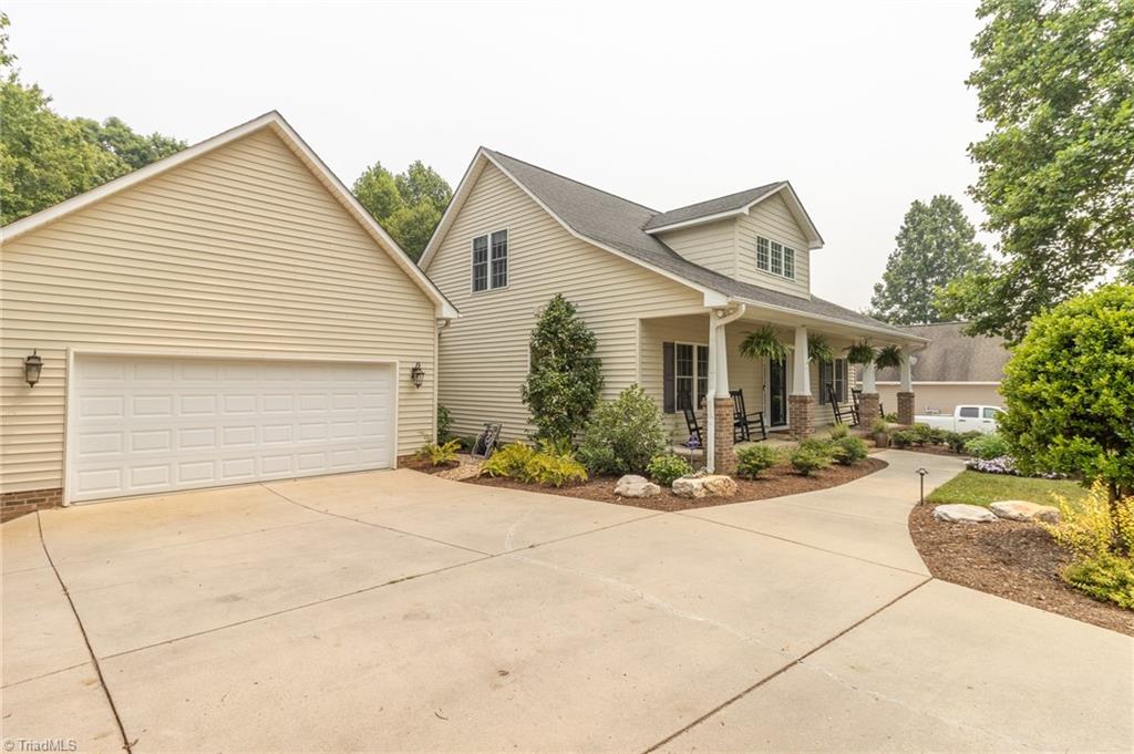 961 Griffin Road Stokesdale, NC 27357 - Photo 3 of 50 Walkway to covered front porch - rocking chairs remain!