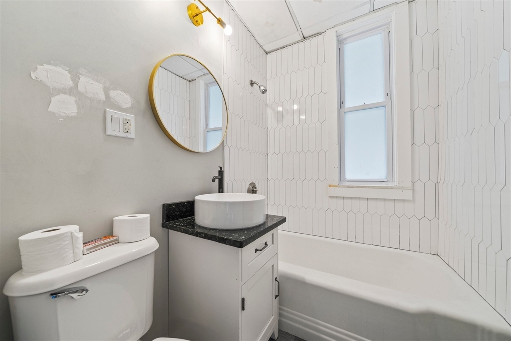 20 Rodney Street Worcester, MA 01605 - Photo 14 of 35 a bathroom with a sink and a mirror