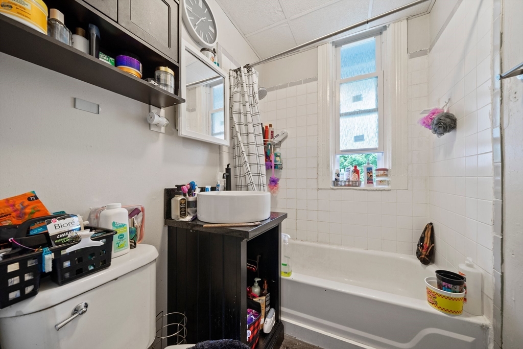 20 Rodney Street Worcester, MA 01605 - Photo 18 of 35 a bathroom with a sink a bath tub and a shower